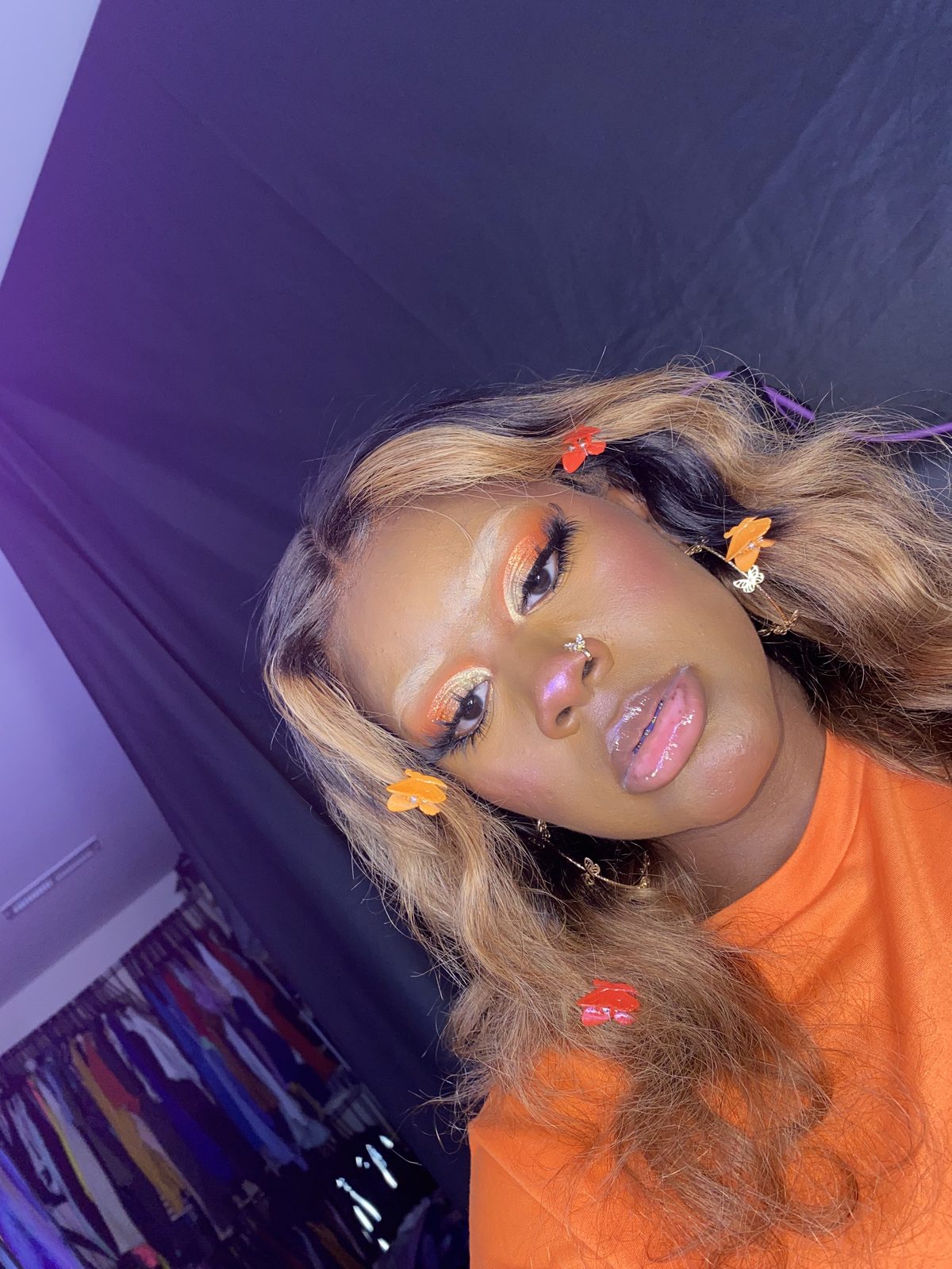 Orange eyeshadow with flower hair clips