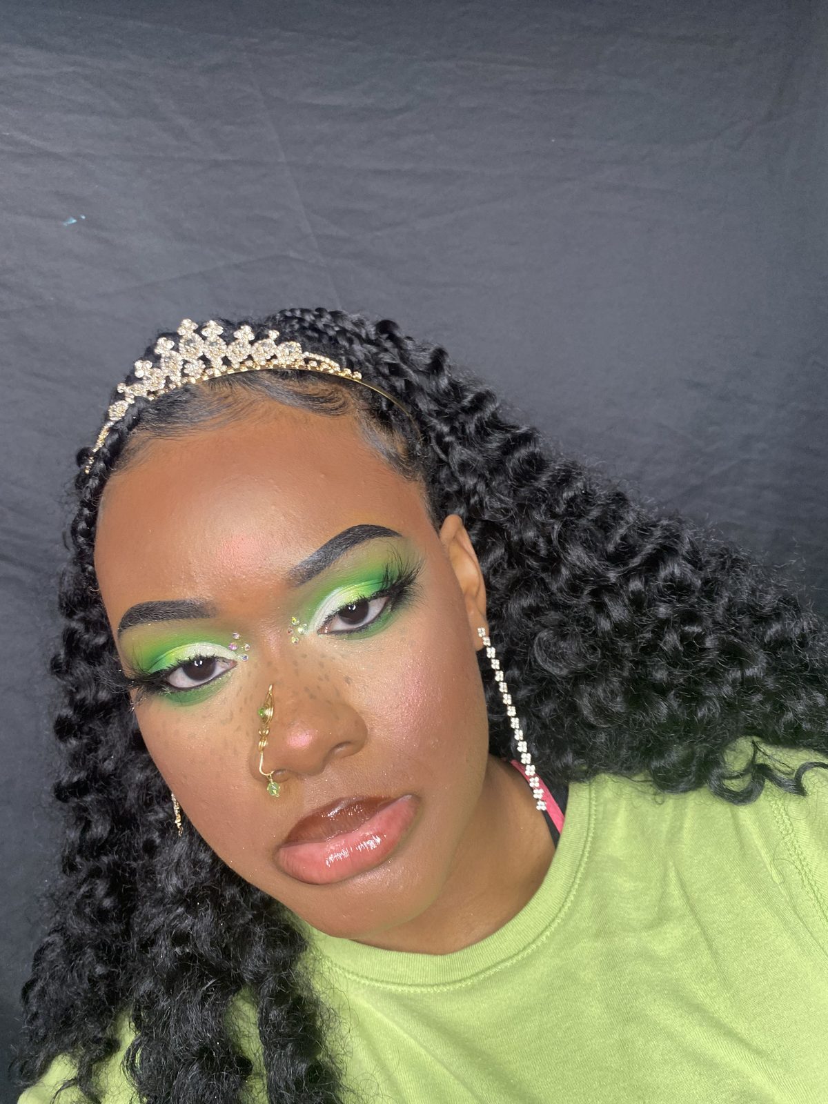 Green eyeshadow look with rhinestone tiara