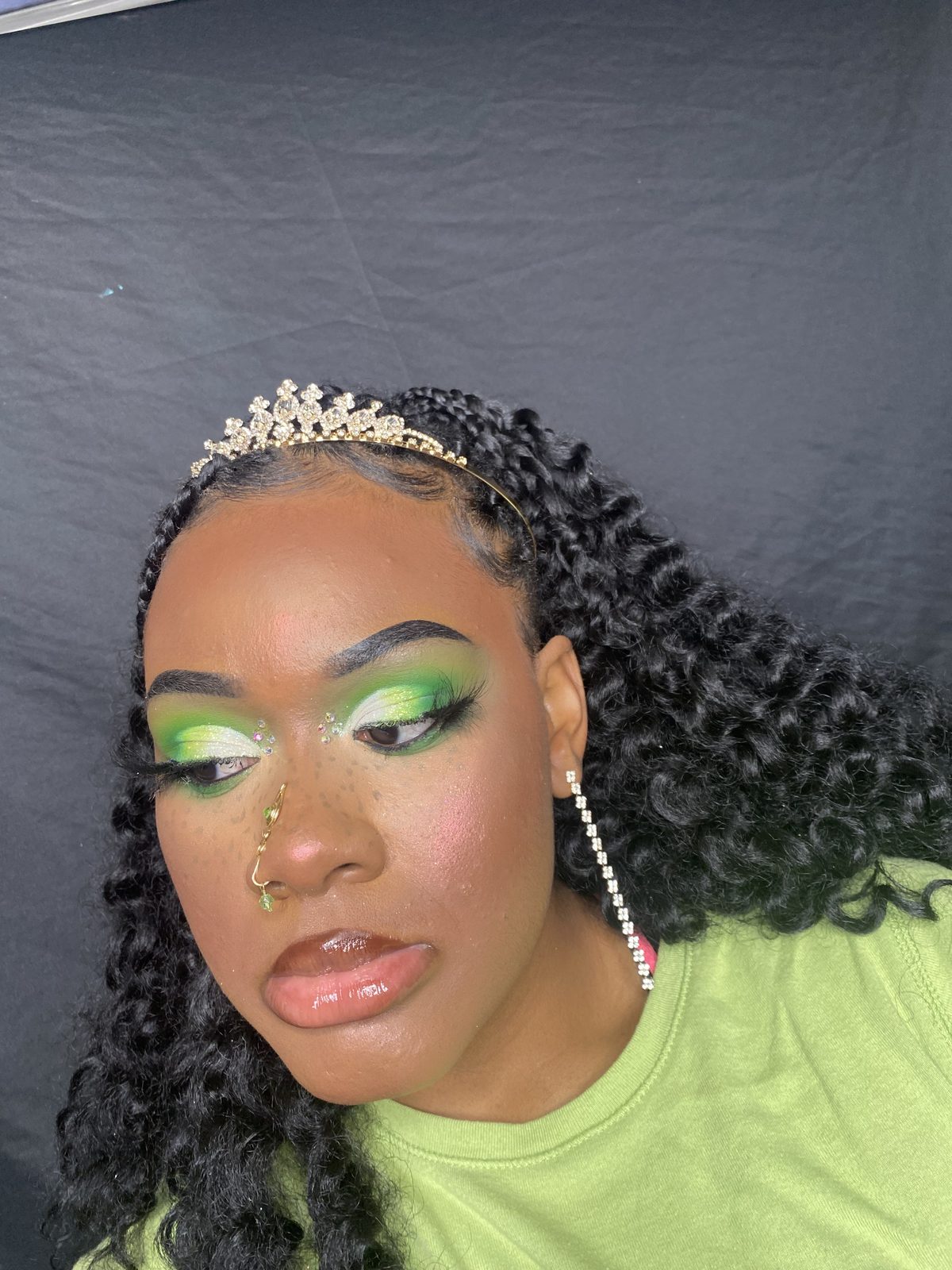 Green eyeshadow with rhinestone tiara alternate angle