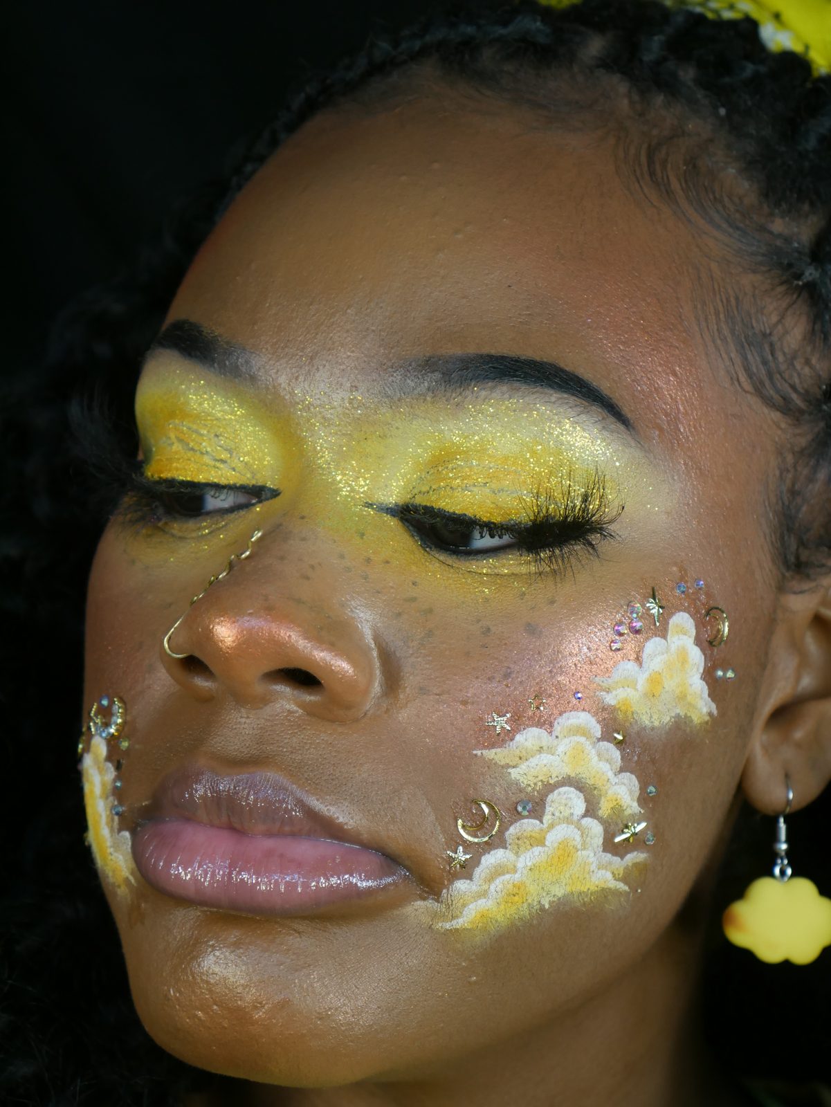 Golden yellow eyes with painted cloud face art